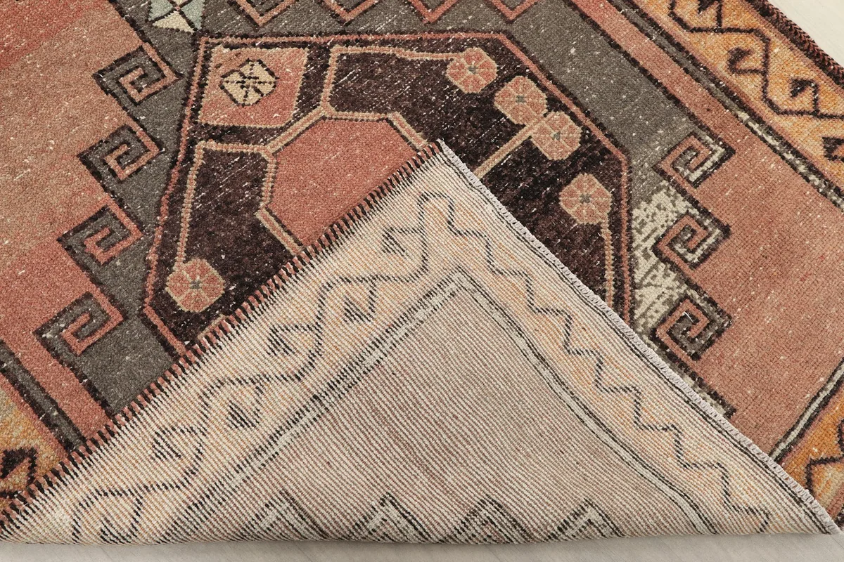 View of the back of the hand-knotted wool runner, revealing the cotton foundation.