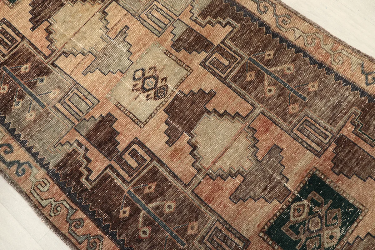 Detailed view of the Earth Tone Geometric Anatolian Runner's tribal patterns and color variations.