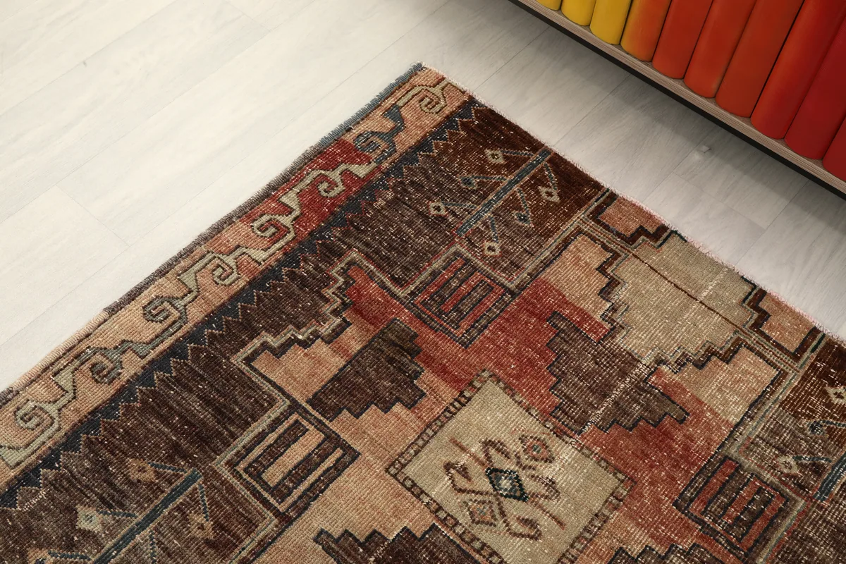 Detail of the Earth Tone Geometric Anatolian Runner's border, with subtle gray and beige motifs.