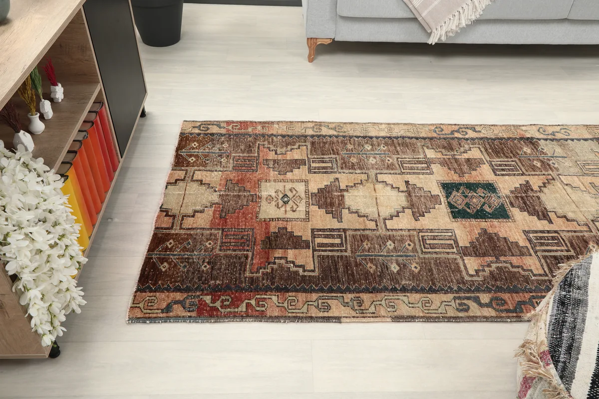 Earth Tone Geometric Anatolian Runner in a room, showing its placement relative to furniture.