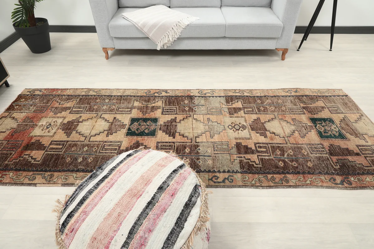 Earth Tone Geometric Anatolian Runner extending across a room, emphasizing its runner size.