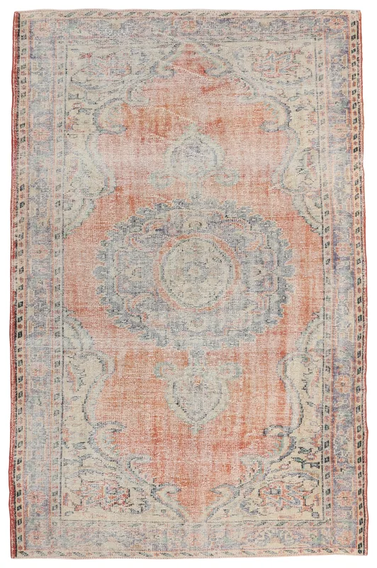 Full overhead view of the orange and blue vintage Anatolian rug on a white background