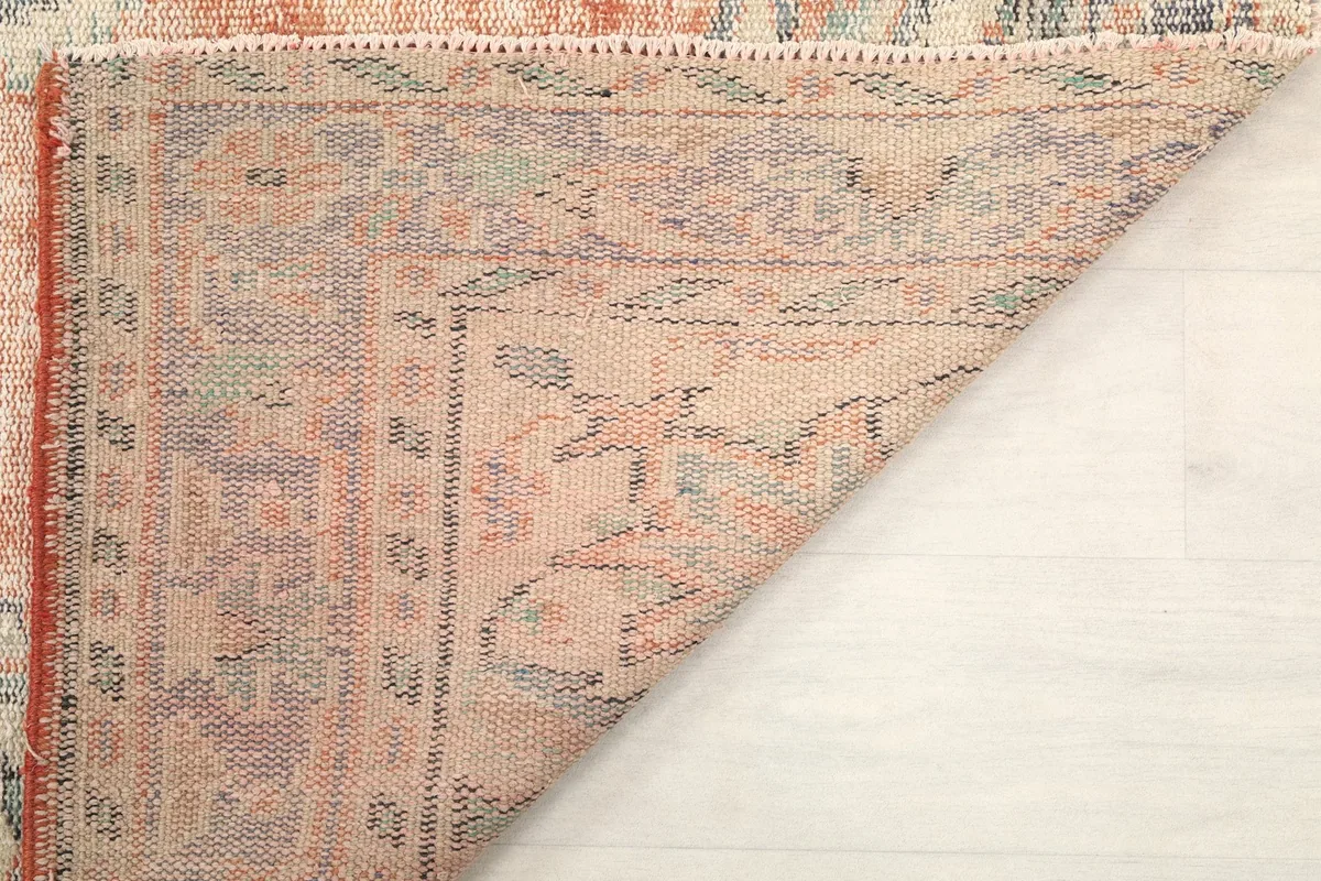 Angled view of the back of the rug, revealing the detailed knotting and a corner