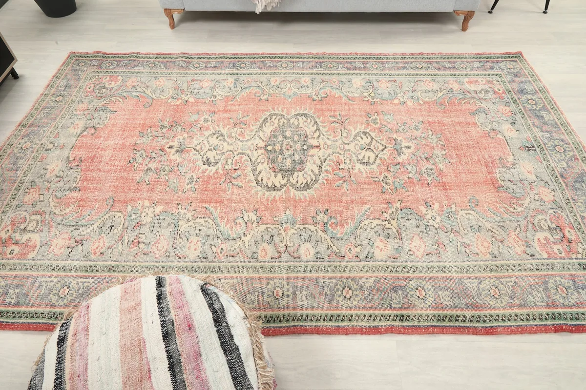 Overhead view showing the full pattern of the rose vintage rug with its medallion and borders
