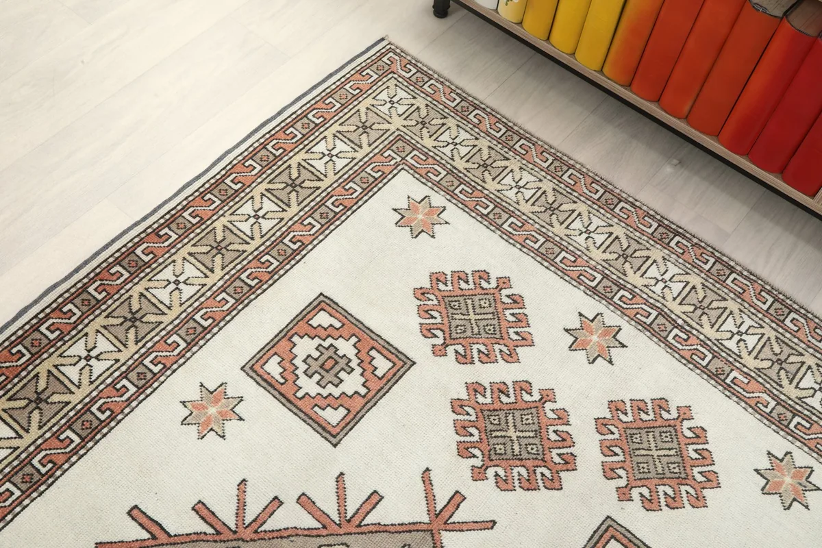 Upper corner detail of the rug, highlighting the geometric border and field motifs.