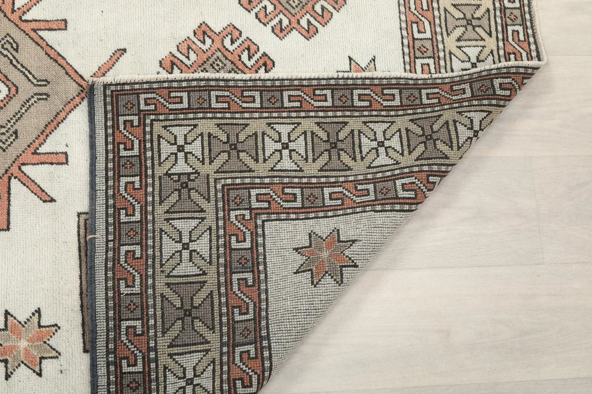 Close-up of the back of the rug, showing the knotting structure and foundation materials.