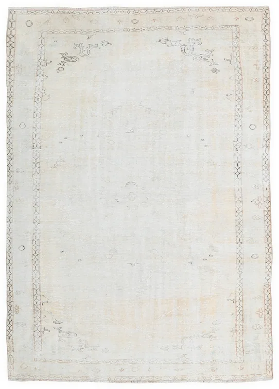 Full overhead view of a 6'4" x 9'3" cream vintage Anatolian area rug with subtle geometric patterns