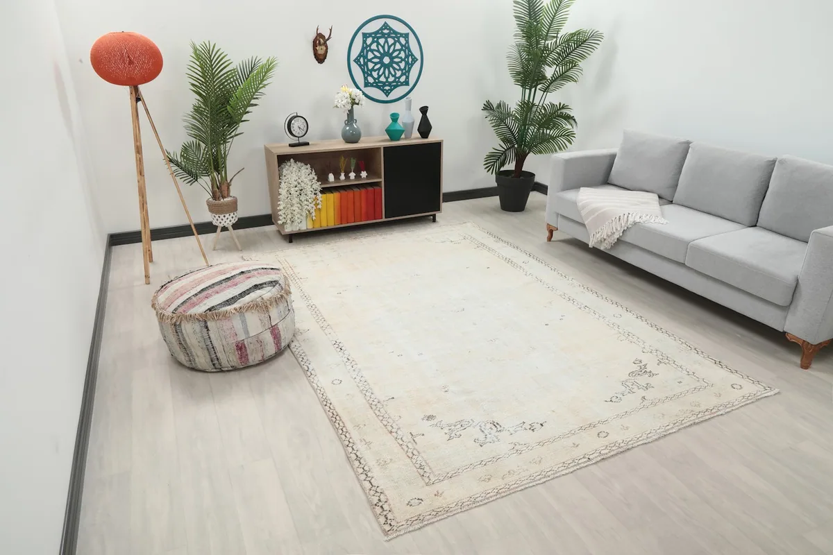 Angle view of the cream vintage rug in a living room, showing its placement relative to furniture