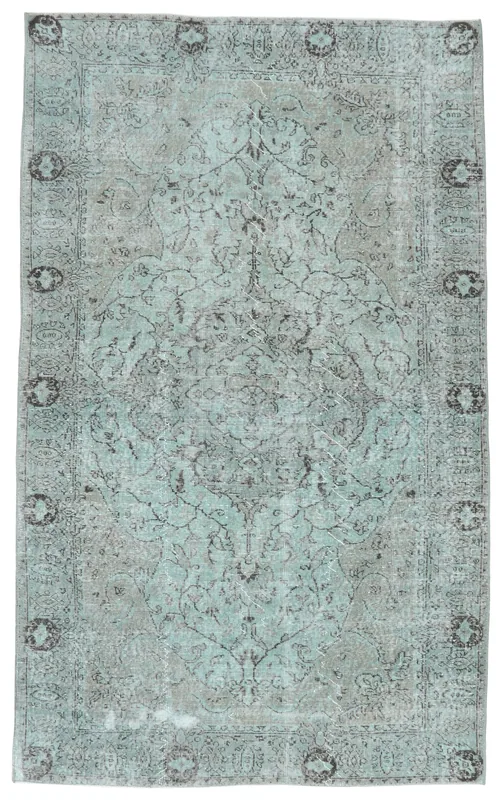 Full overhead view of the blue and gray medallion vintage Anatolian area rug on a white background