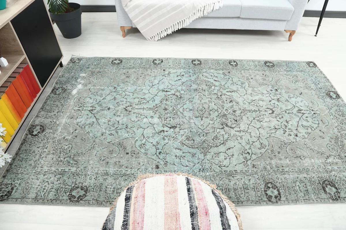 Rug in a room setting from a different angle, showing the blue tones and decorative elements