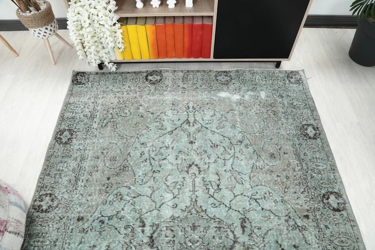 Overhead view showing the full length of the rug, capturing its overall design and distressed character