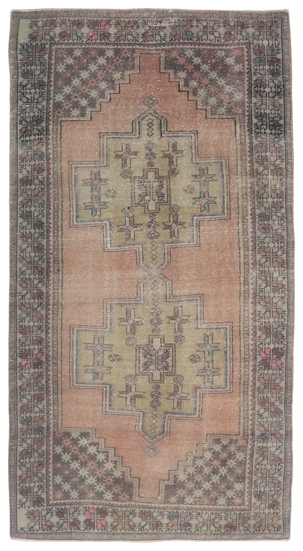 Full overhead view of the vintage Anatolian rug with rose field and olive geometric medallion