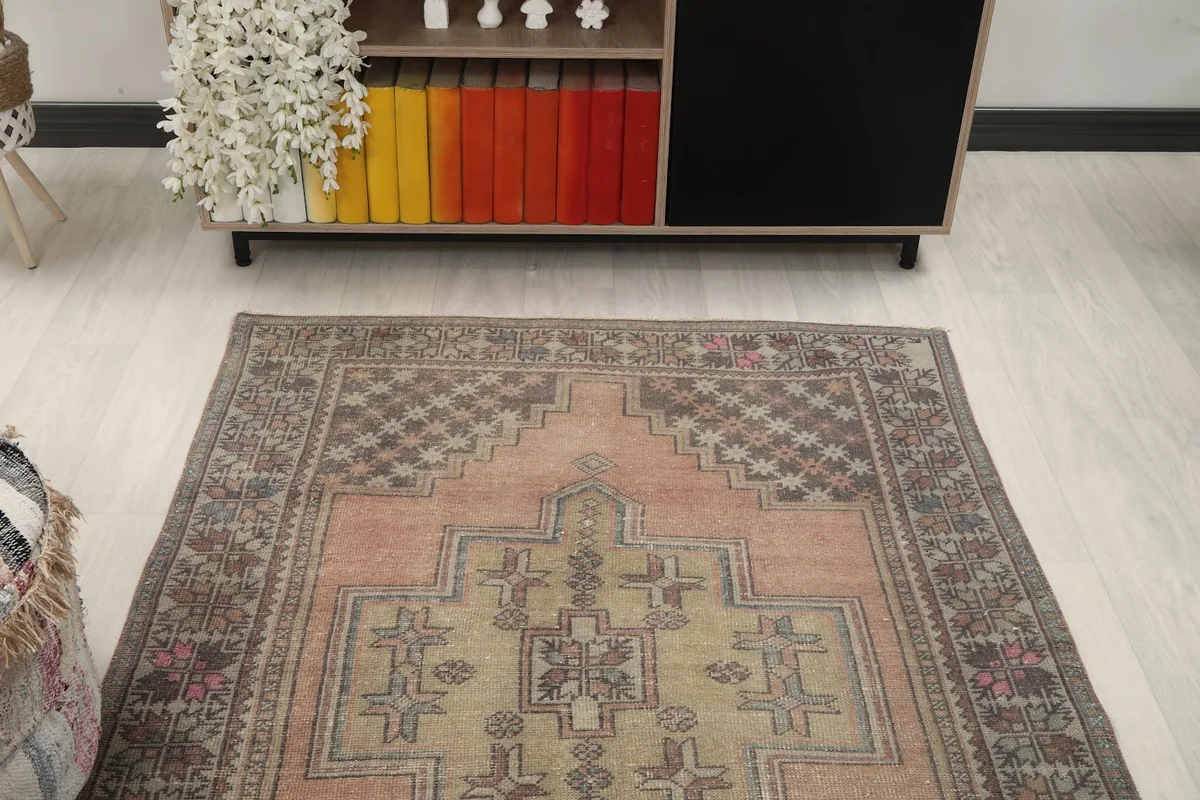 Overhead angle view of the rug's top section, highlighting the border and upper part of the medallion