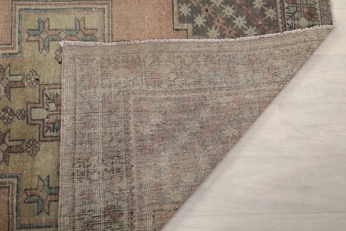 Another view of the rug's back, showing the tight knotting and vintage condition of the foundation