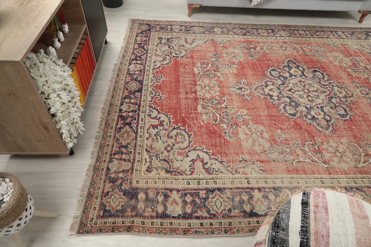 Wide shot of the red Anatolian rug in a room from a different angle, showing its integration with decor