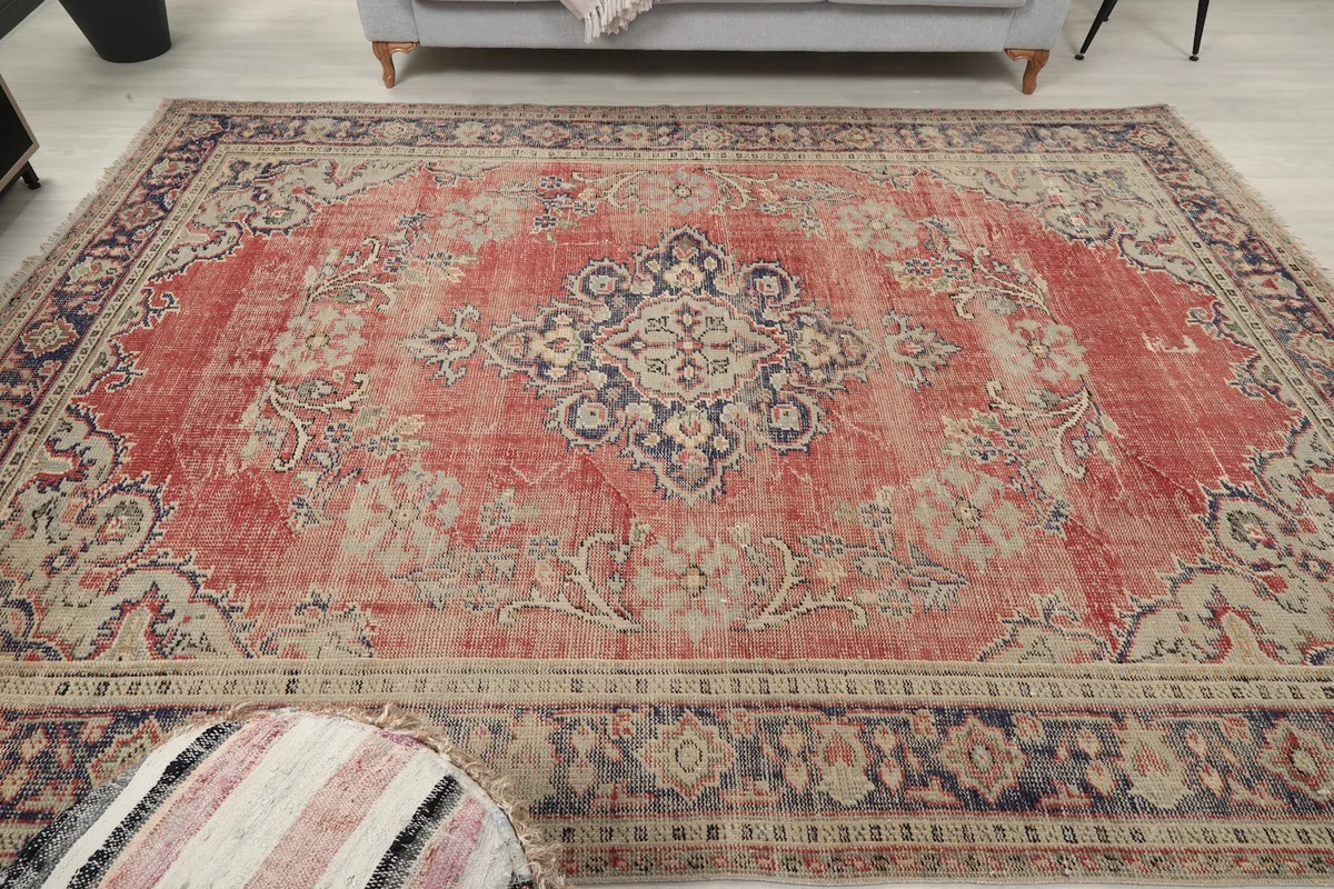 Overhead view of the red medallion rug in a room setting, capturing its overall presence
