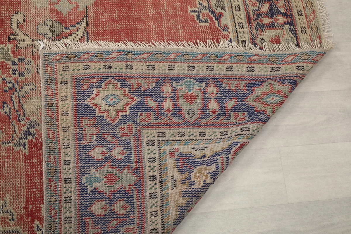Another view of the rug's corner folded, showing the dense knotting on the reverse side