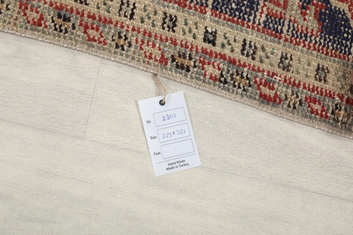 Close-up of the product tag indicating rug dimensions and origin, resting on the floor next to the rug