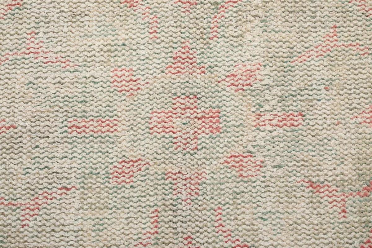 Underside view of the rug, revealing the tightly woven cotton foundation and knotting