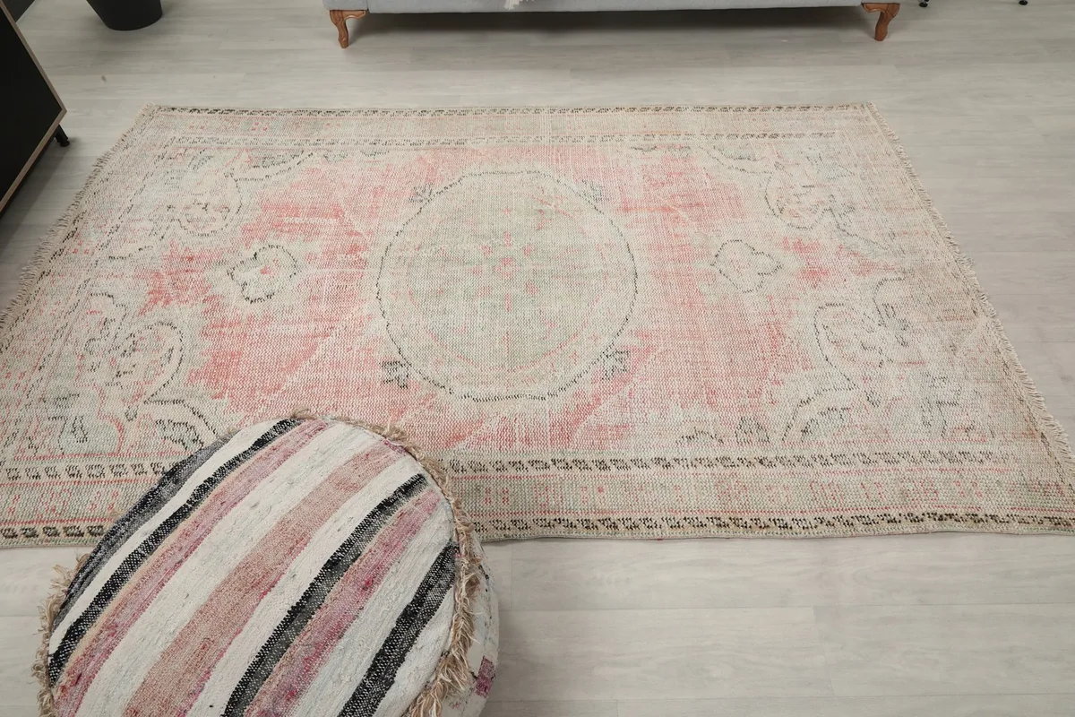 Overhead view of the entire rose and gray medallion rug, showcasing its dimensions in the room