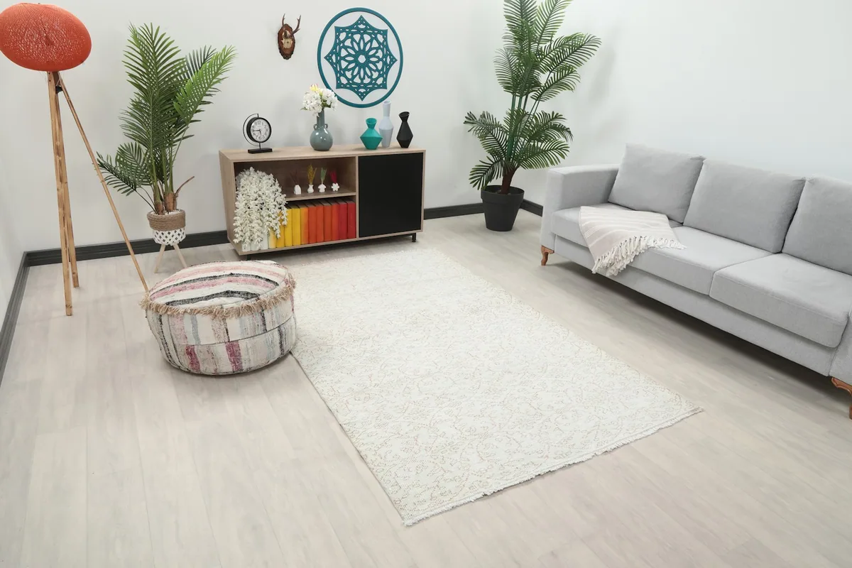 Angle view of the medium-sized cream rug in a living space with light-colored furniture
