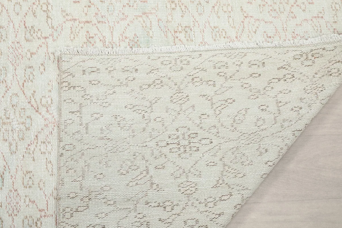 Detail of the rug's back and a glimpse of the front, illustrating the quality of the knotting