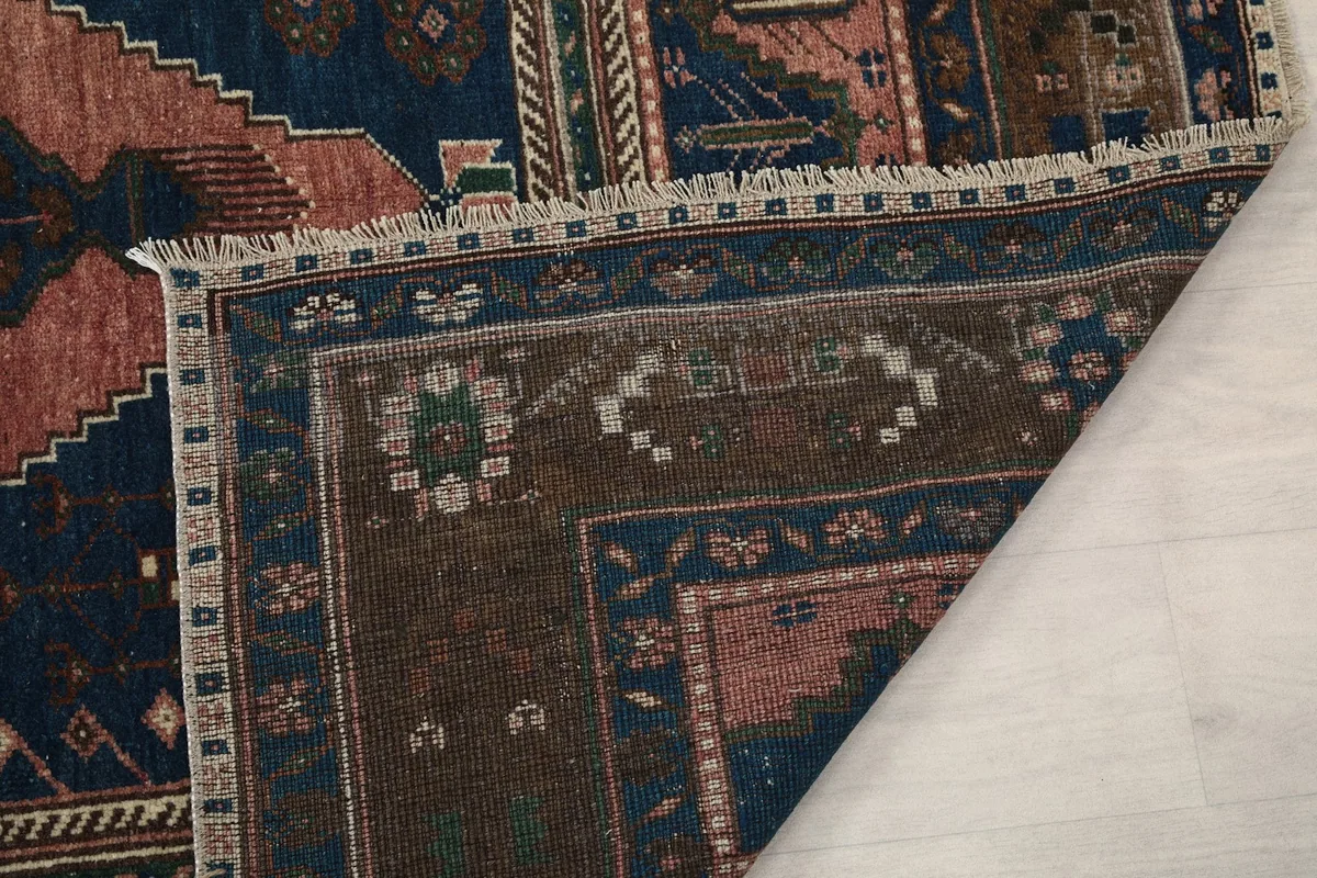 Close-up of the back of the rug and the reverse side of a corner, showing the knotting structure.