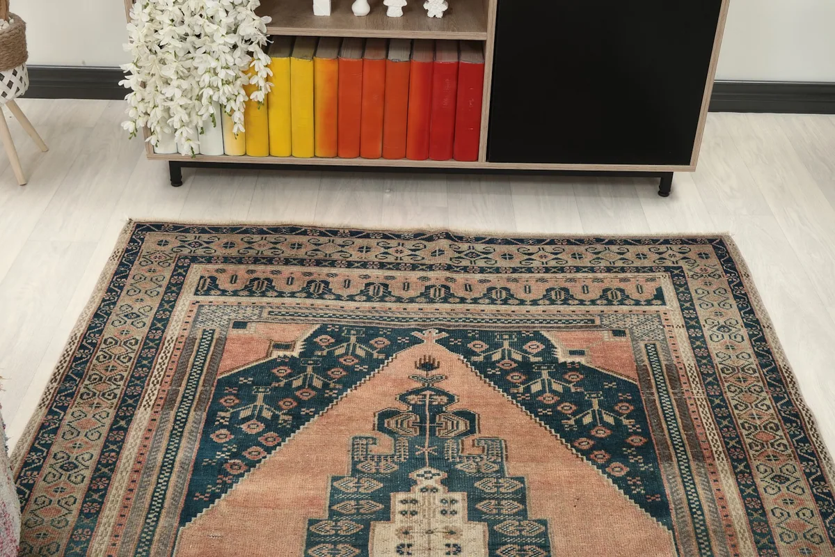 Overhead angled view of the rug's top portion, showing the border and field pattern