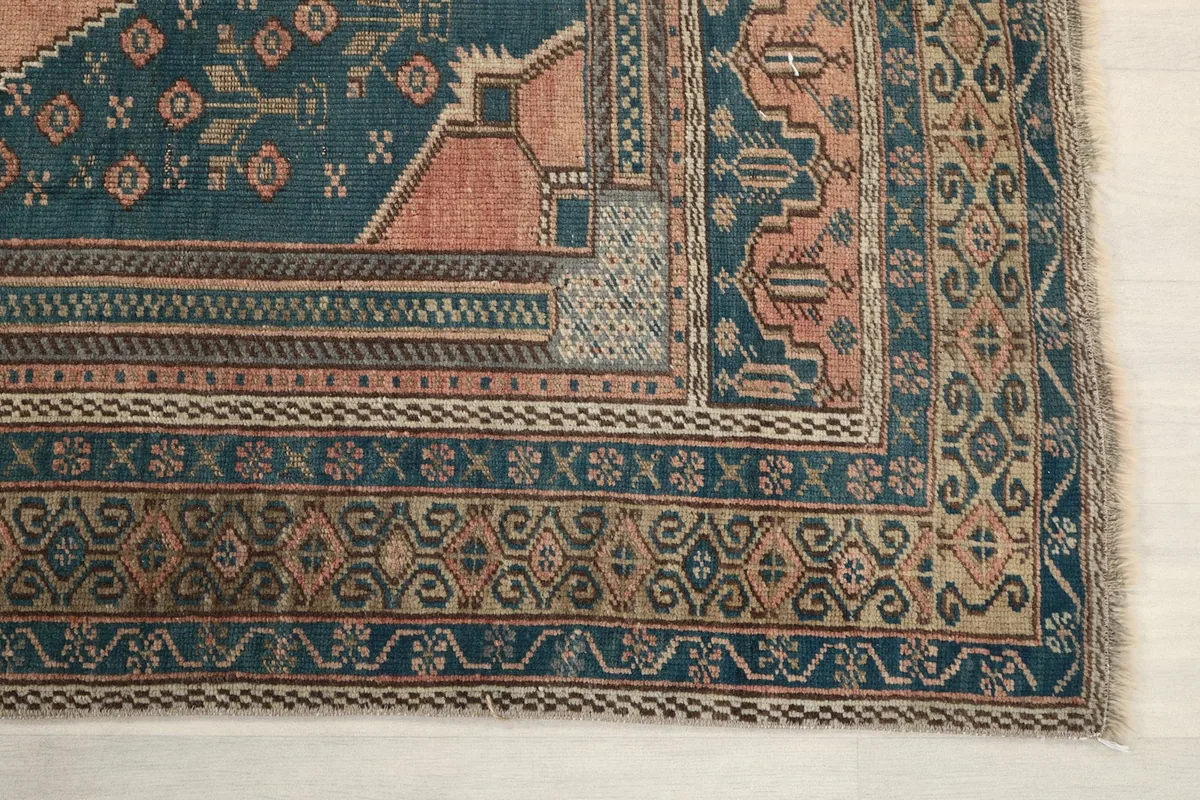 Corner detail showing the intricate blue and beige borders and geometric patterns
