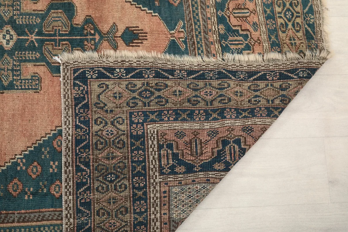 Close-up of the rug's reverse side, showing the hand-knotted cotton foundation