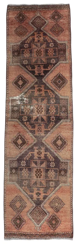 Full overhead view of the rust and brown geometric vintage Anatolian runner rug on a white background.