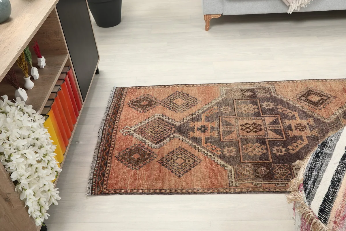 Side view of the runner rug in a room, highlighting its length and the flow of its geometric design.