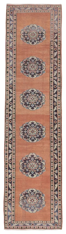 Full top view of the 2'7" x 10'1" rust vintage Anatolian runner rug on a white background.