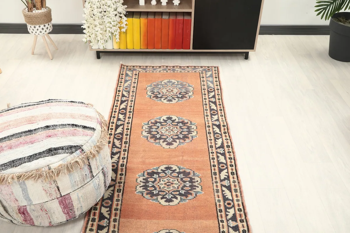 Overhead view of the rust runner rug in a room, capturing its full pattern and colors.