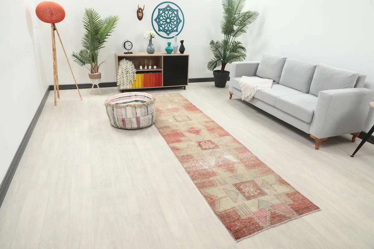 Long view of the rose and beige runner in a room, showing its length and placement