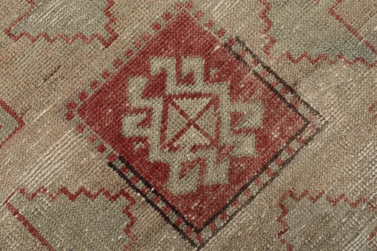Extreme close-up of a central diamond-shaped motif with intricate tribal designs