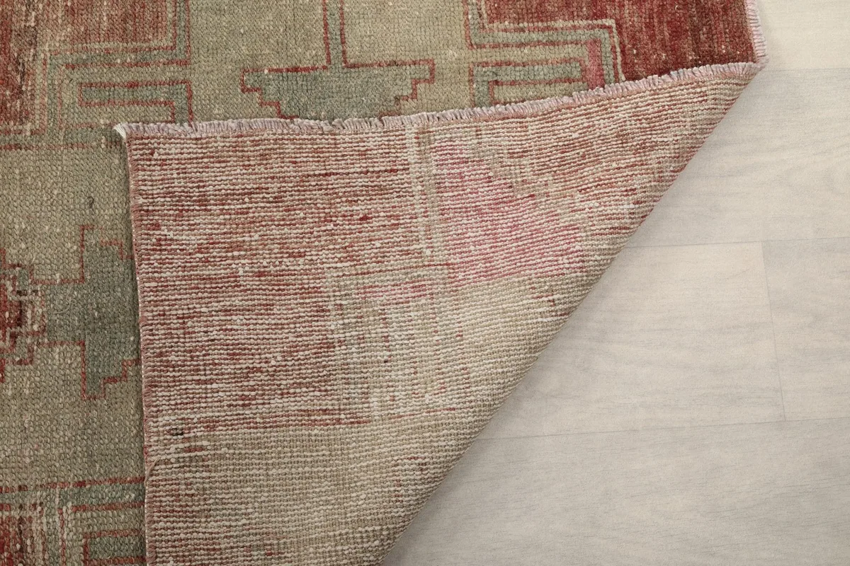 Close-up of the back of the rug, showing the dense hand-knotting and cotton foundation