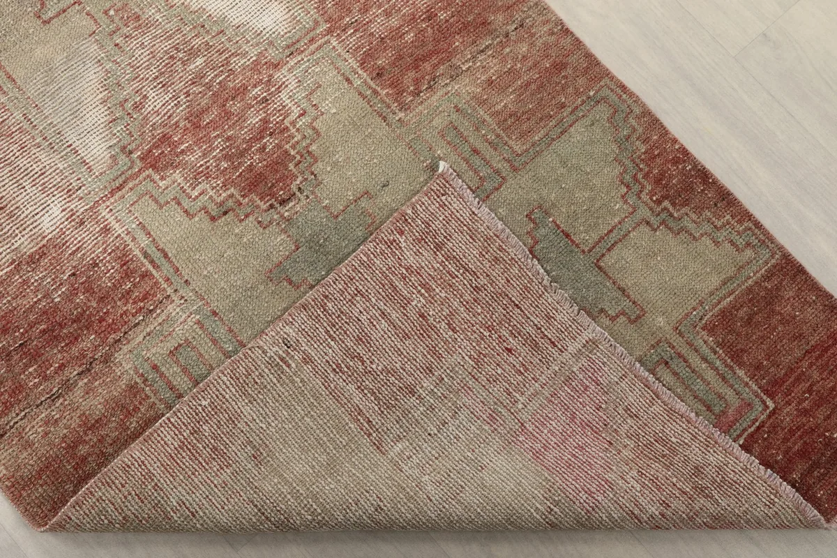 Corner of the runner folded back to reveal the back of the hand-knotted wool on cotton foundation