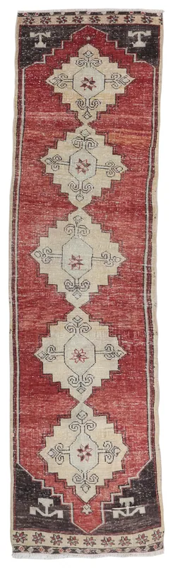 Full overhead view of the rust, ivory, and charcoal geometric Anatolian runner on a white background.