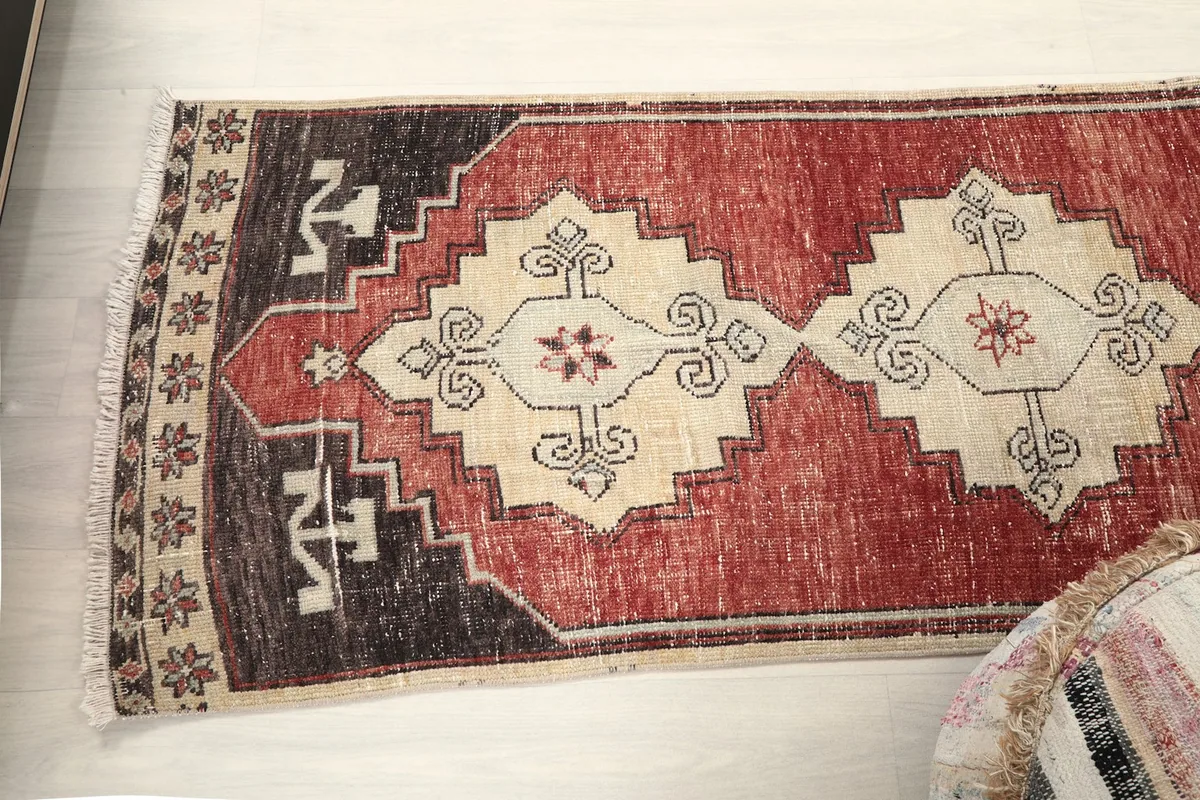 Angled view of the rug's top half, showing the repeating geometric patterns.