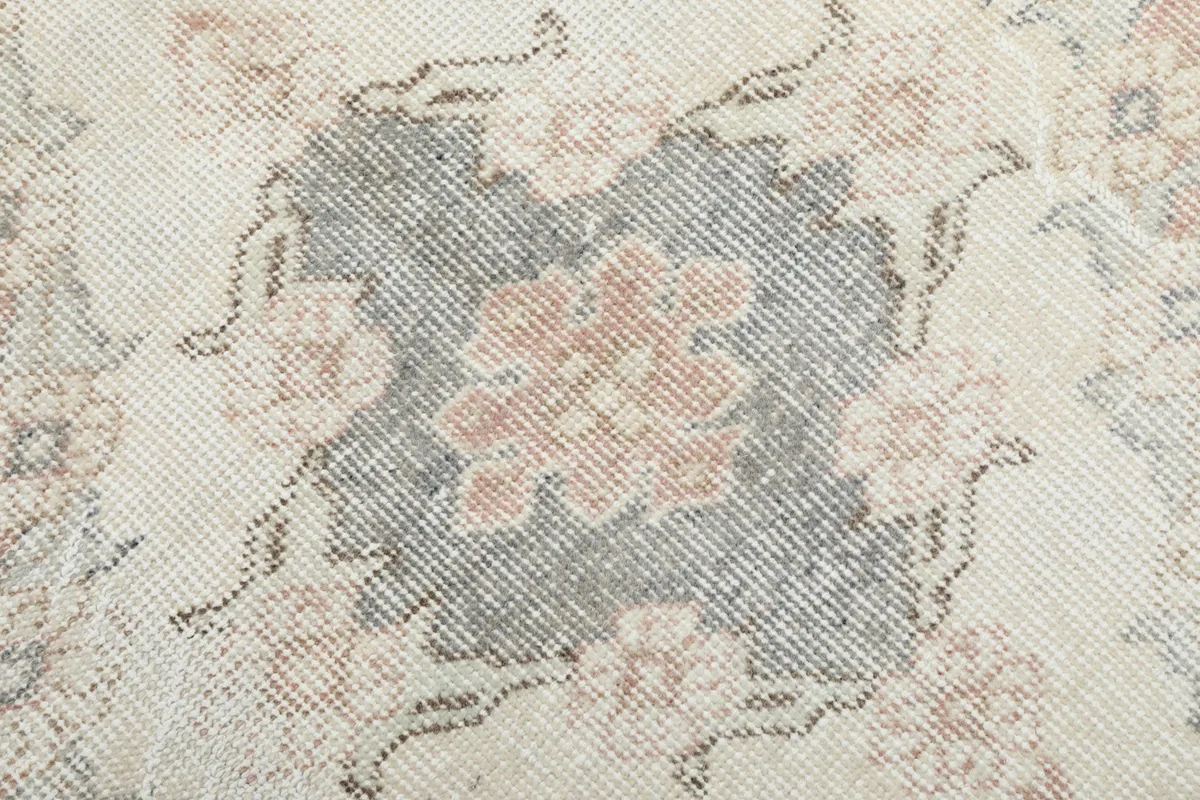 Detailed view of the low wool pile, revealing the hand-knotted texture and color variations.
