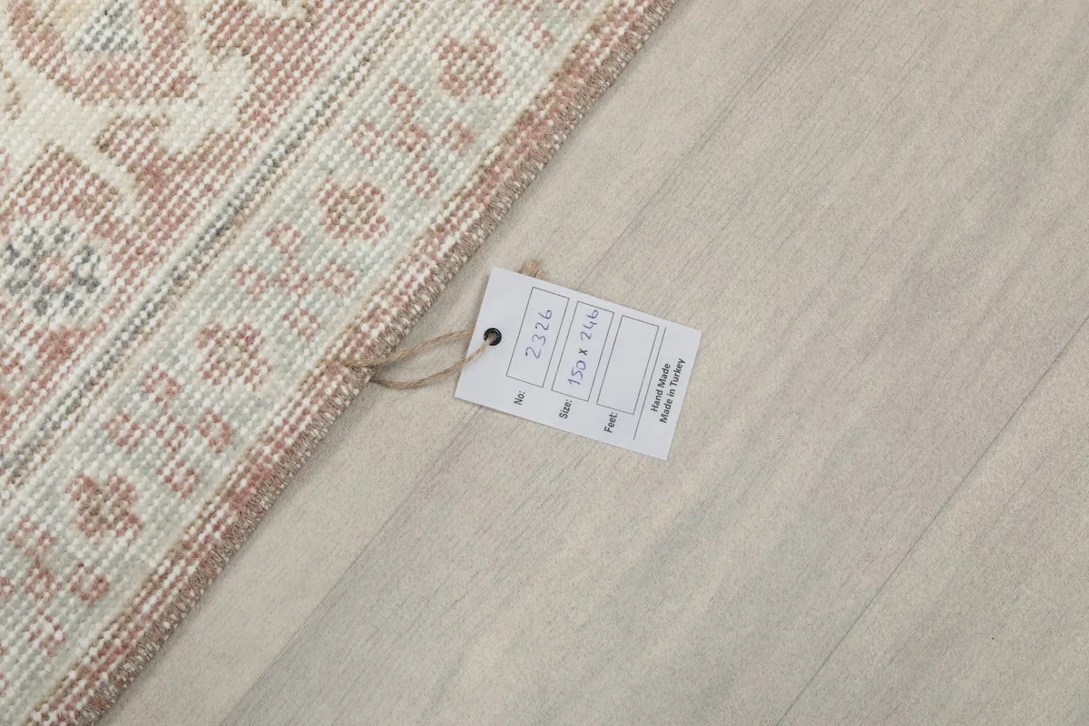 Corner of the rug with the product tag, showing size and origin details.