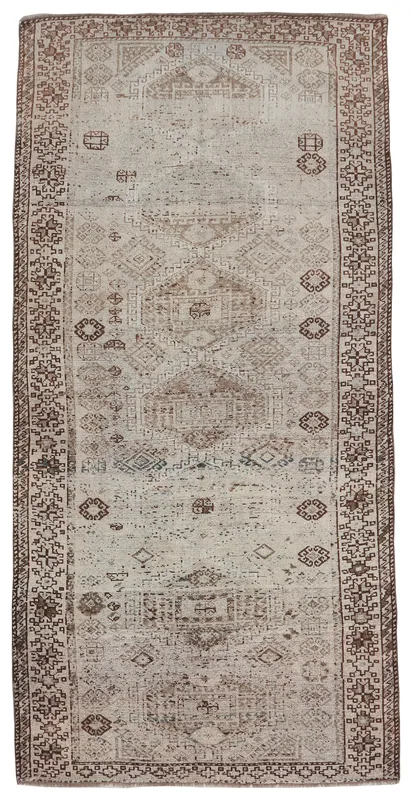 Full top view of the 4'8" x 10'1" beige and brown vintage Anatolian area rug on a white background.