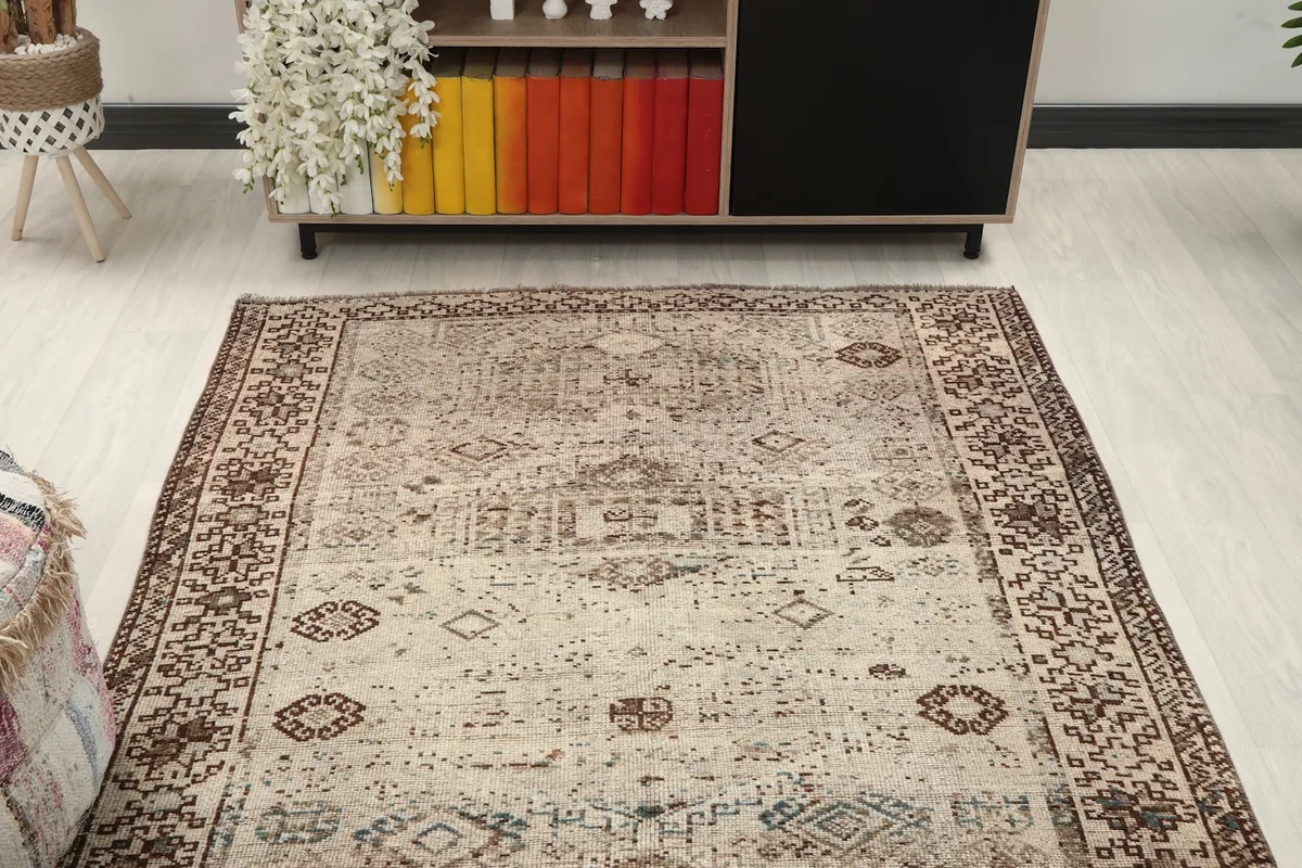 Overhead view of the rug in a room, capturing its full length and the interplay of beige and brown.