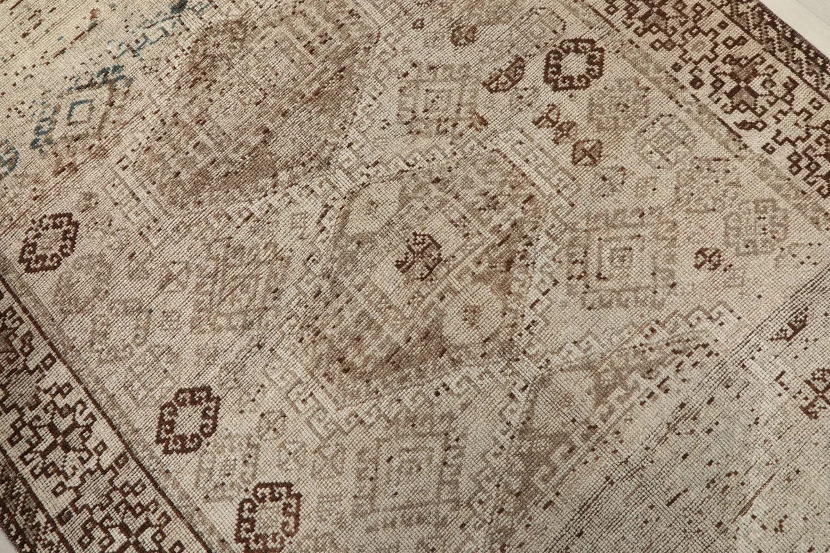 Close-up of the central field, showcasing varied beige and brown hues and distressed tribal designs.