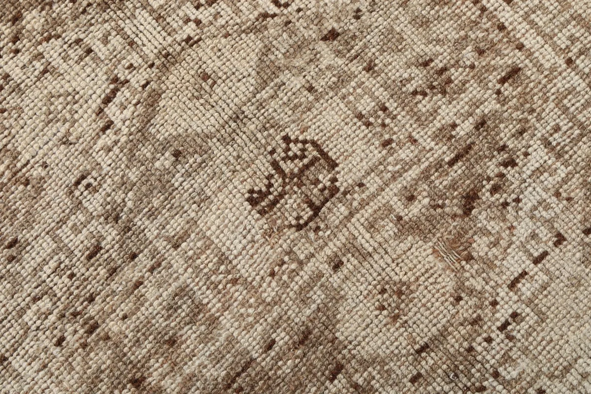 Macro view of the low wool pile, showing the tight knotting and texture of the vintage rug.
