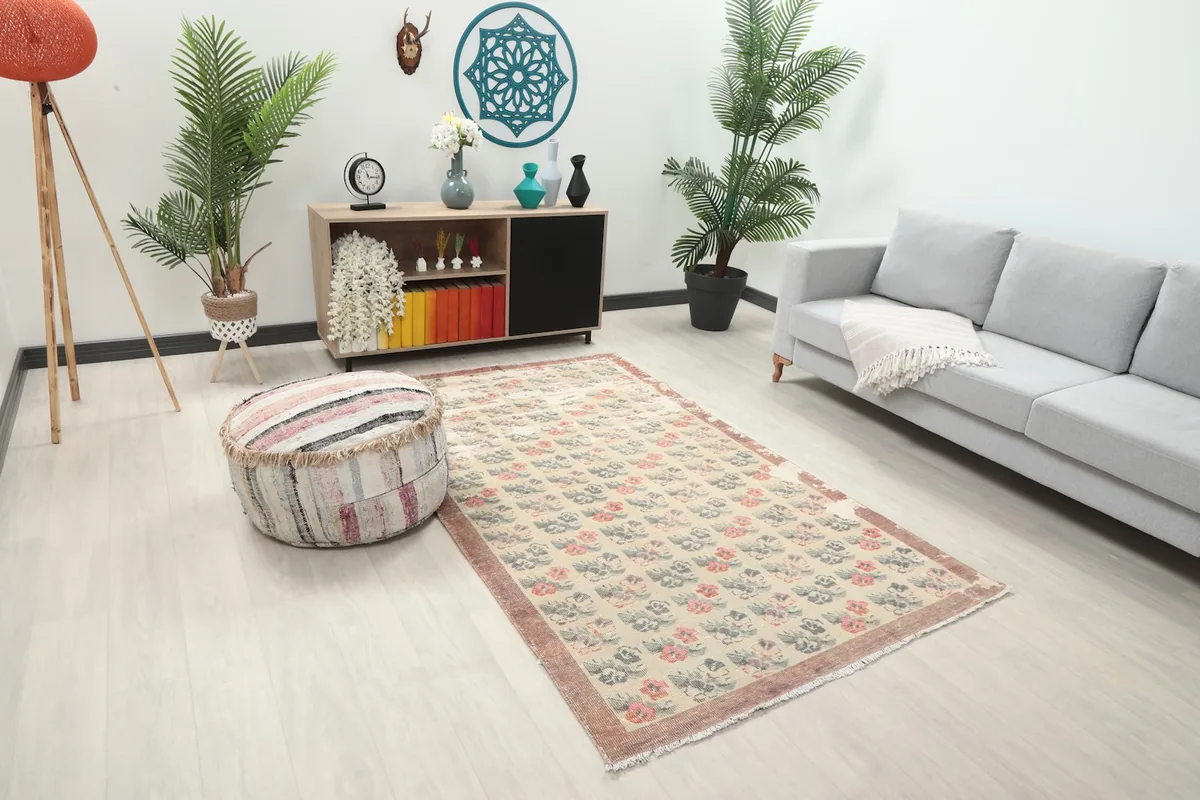 Anatolian rug in a living space, showing its placement relative to a sofa and ottoman.