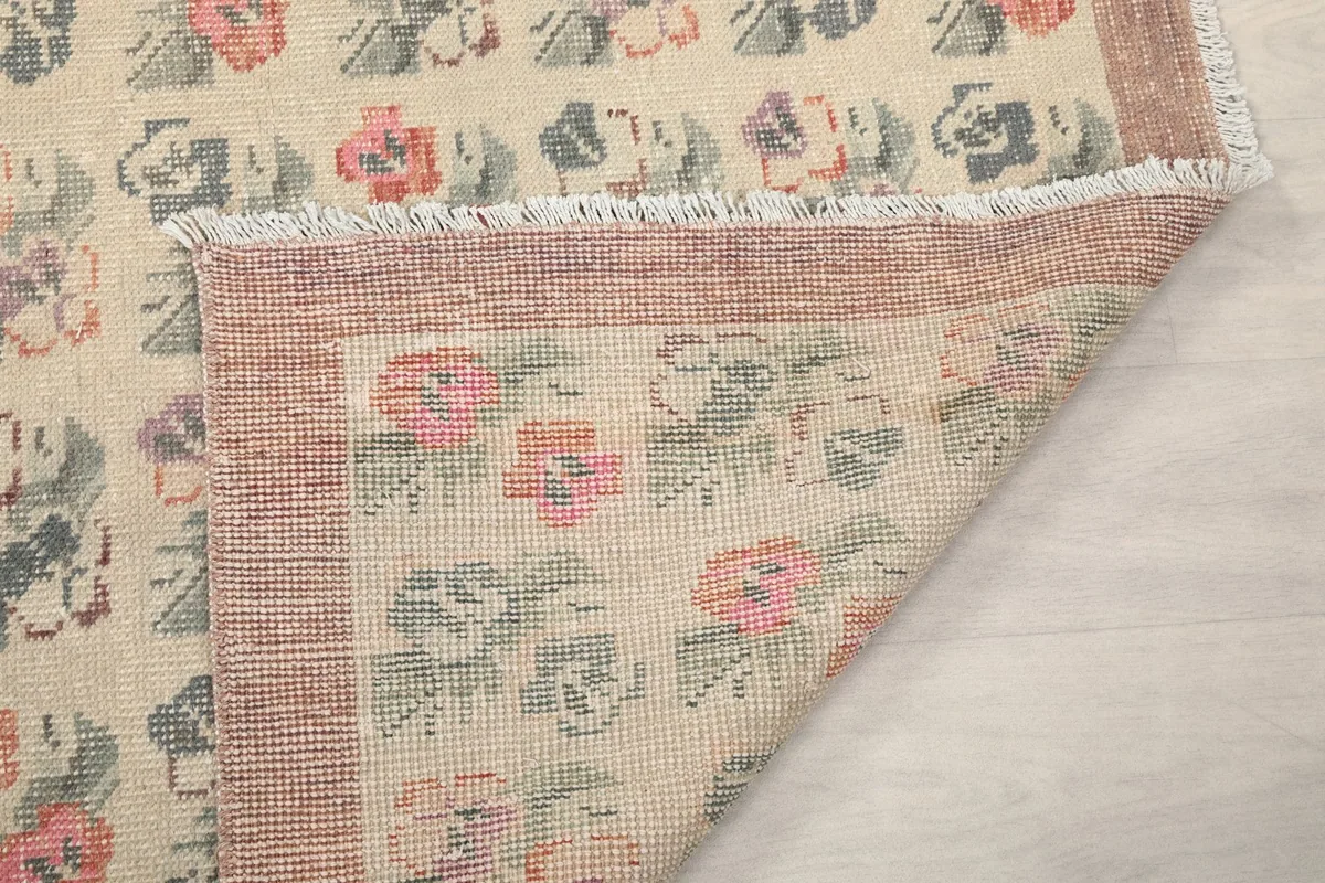 Close-up of the rug's reverse side and fringe, indicating hand-knotted craftsmanship.