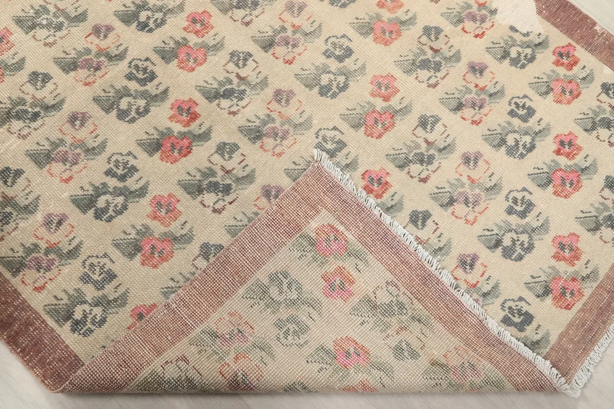 Corner of the rug folded back, revealing the reverse side and the construction.