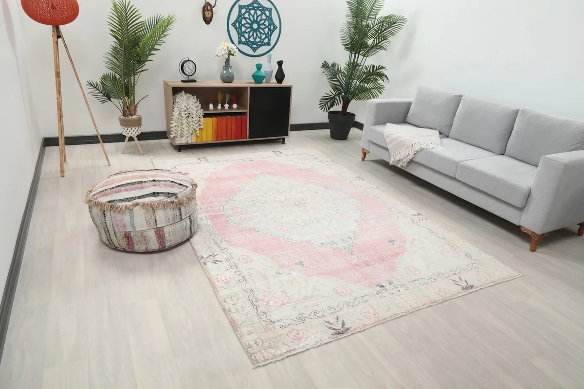 Angled view of the hand-knotted rug in a living room, highlighting its size and placement.